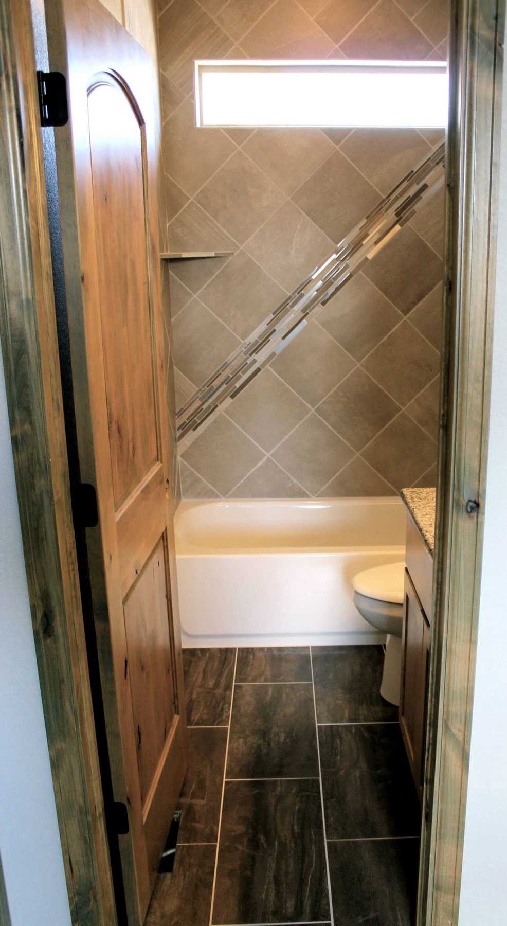 Black scallop tile bathroom with gold fixtures
